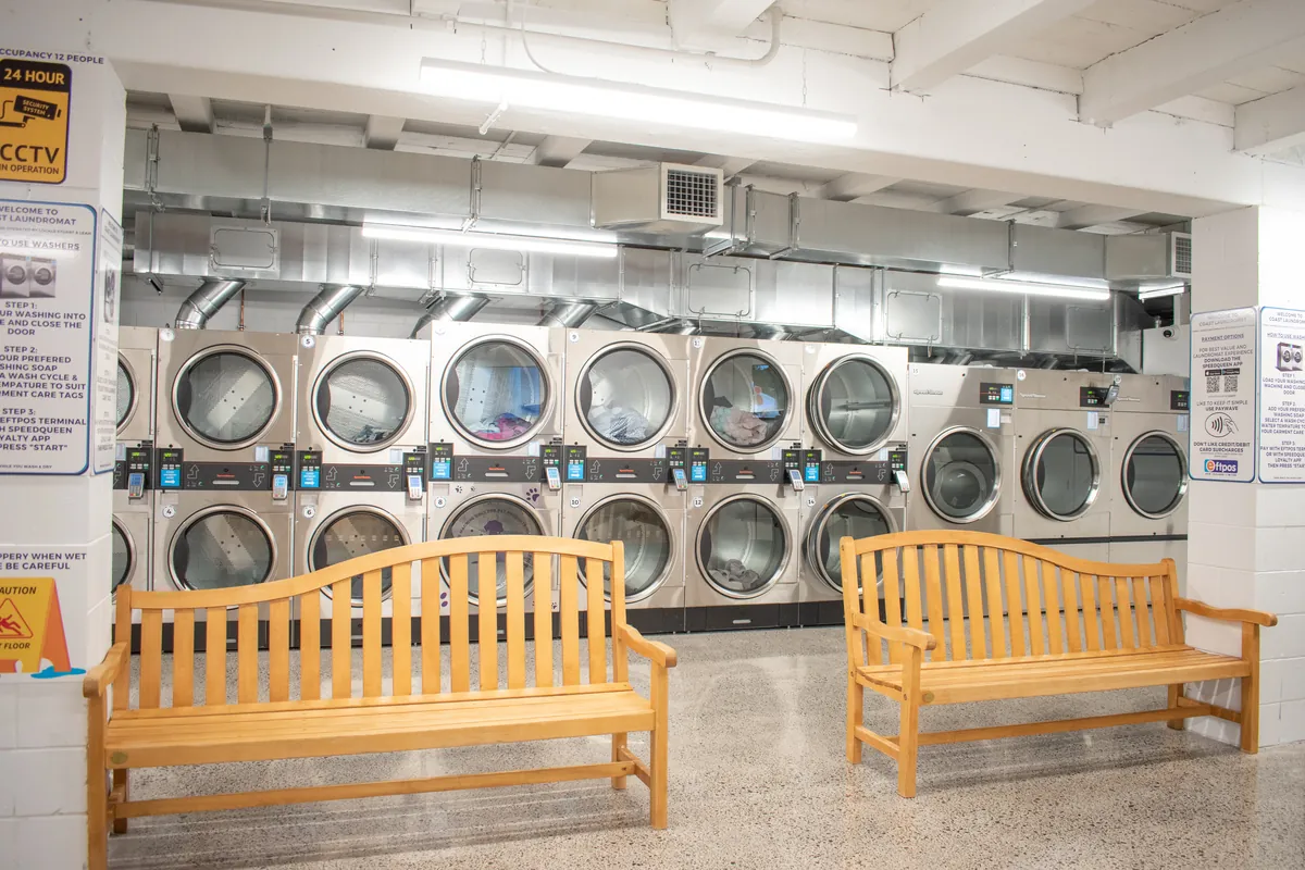 Wall of large stacked tumble dryers at Coast Laundromat near Orewa